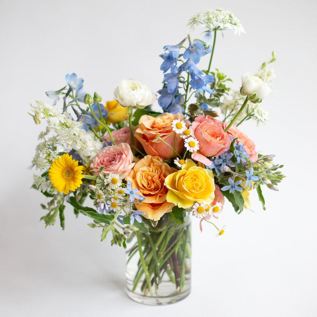 colorful flowers in a small glass vase