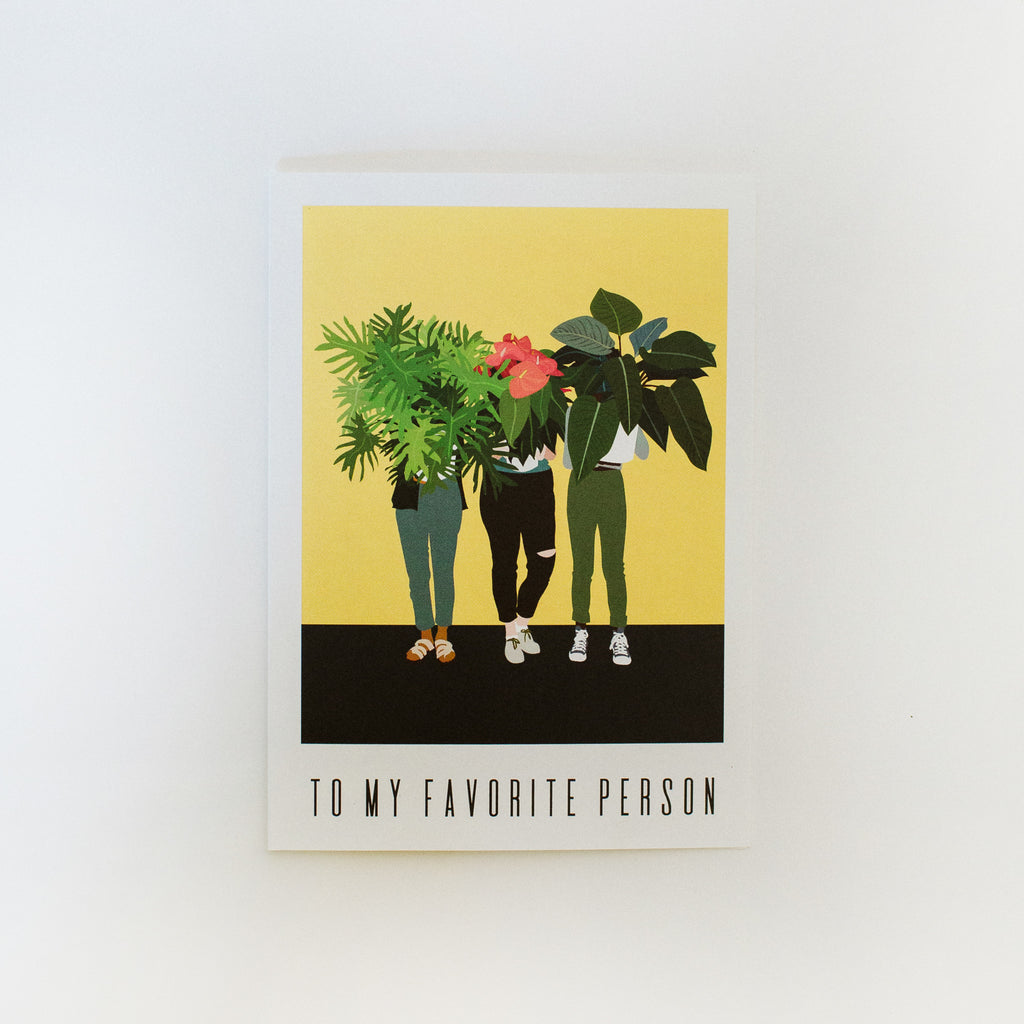 A greeting card that reads "to my favorite person". The artwork on it is of three people holding potted plants in front of their faces.