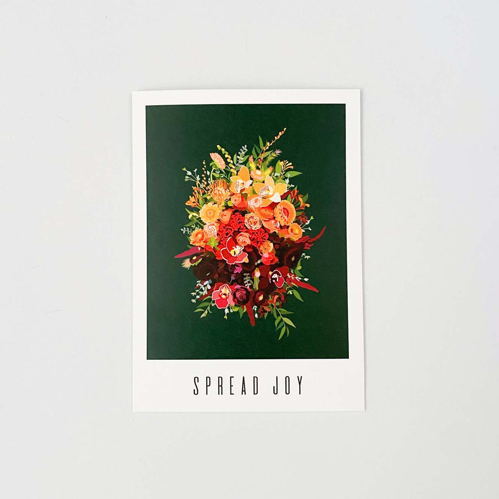 A greeting card that reads "spread joy". The artwork on it is of a gold and red flower bouquet on a dark green background.