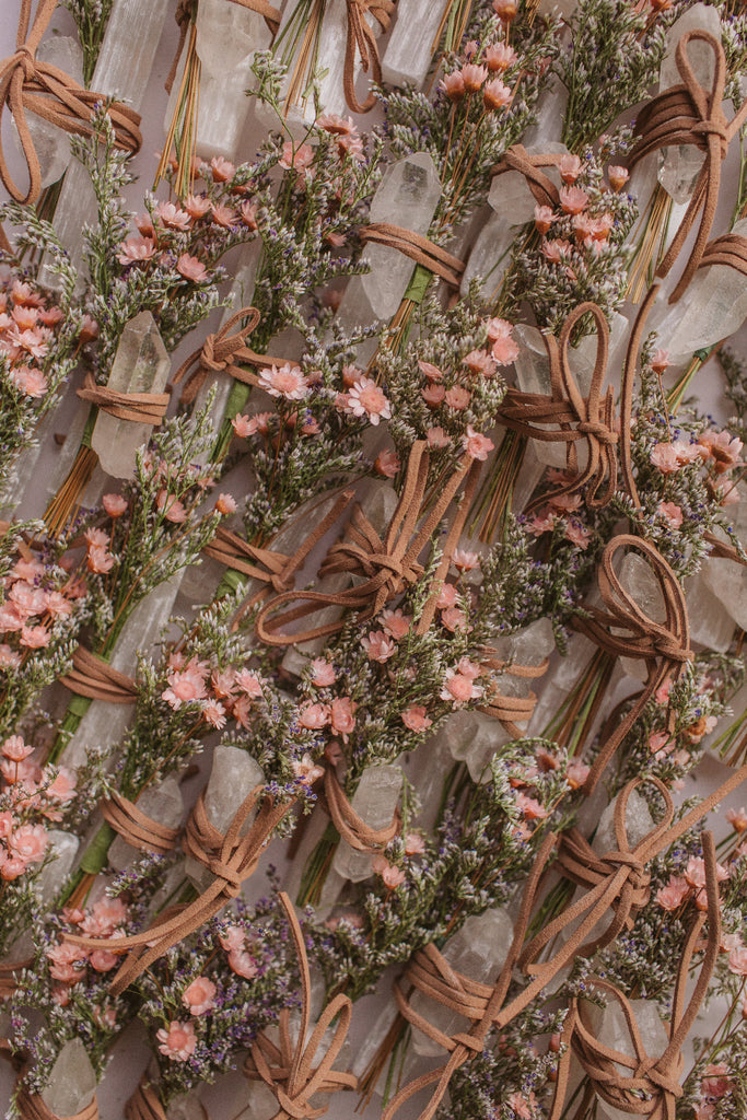 a bunch of crystal bundles, tied with a tiny decorative spring of dried flowers