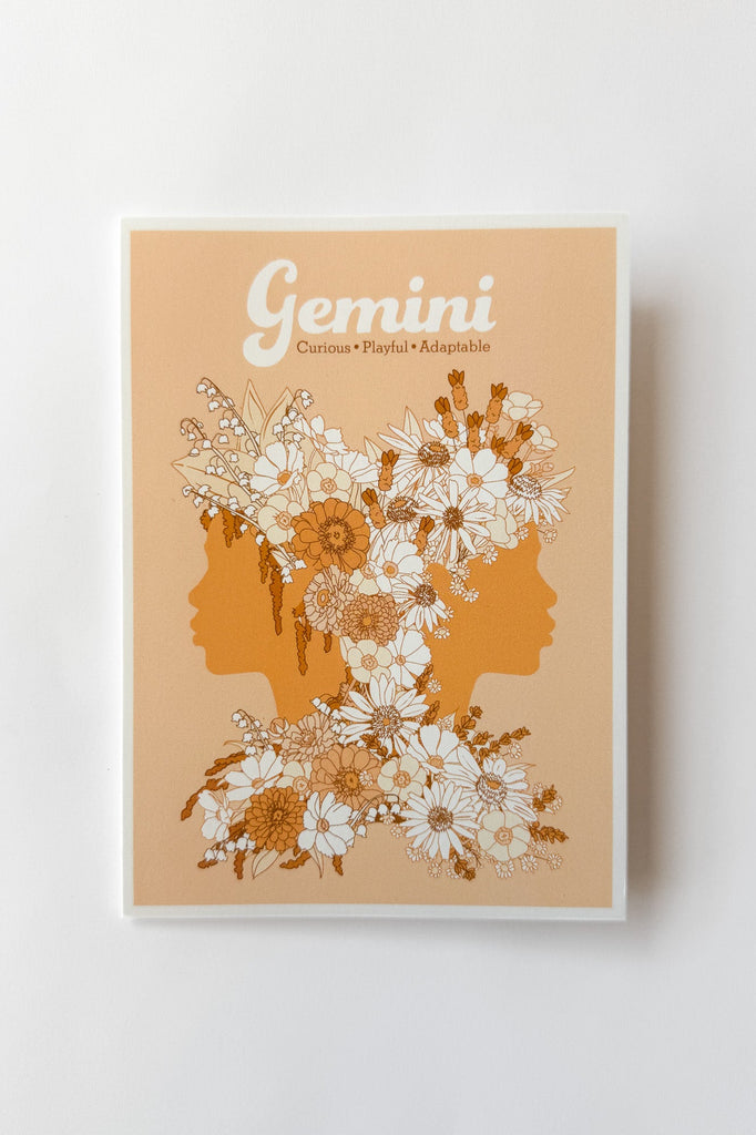 A Gemini-themed greeting card featuring two profile silhouettes in tangerine and orange, decorated with white and peach flowers, on a light orange background with the word 'Gemini' at the top.