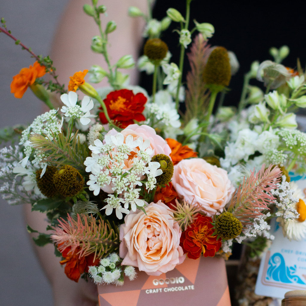a floral palette with peach, red, orange, and white, including spray rose, queen anne's lace, and marigolds.