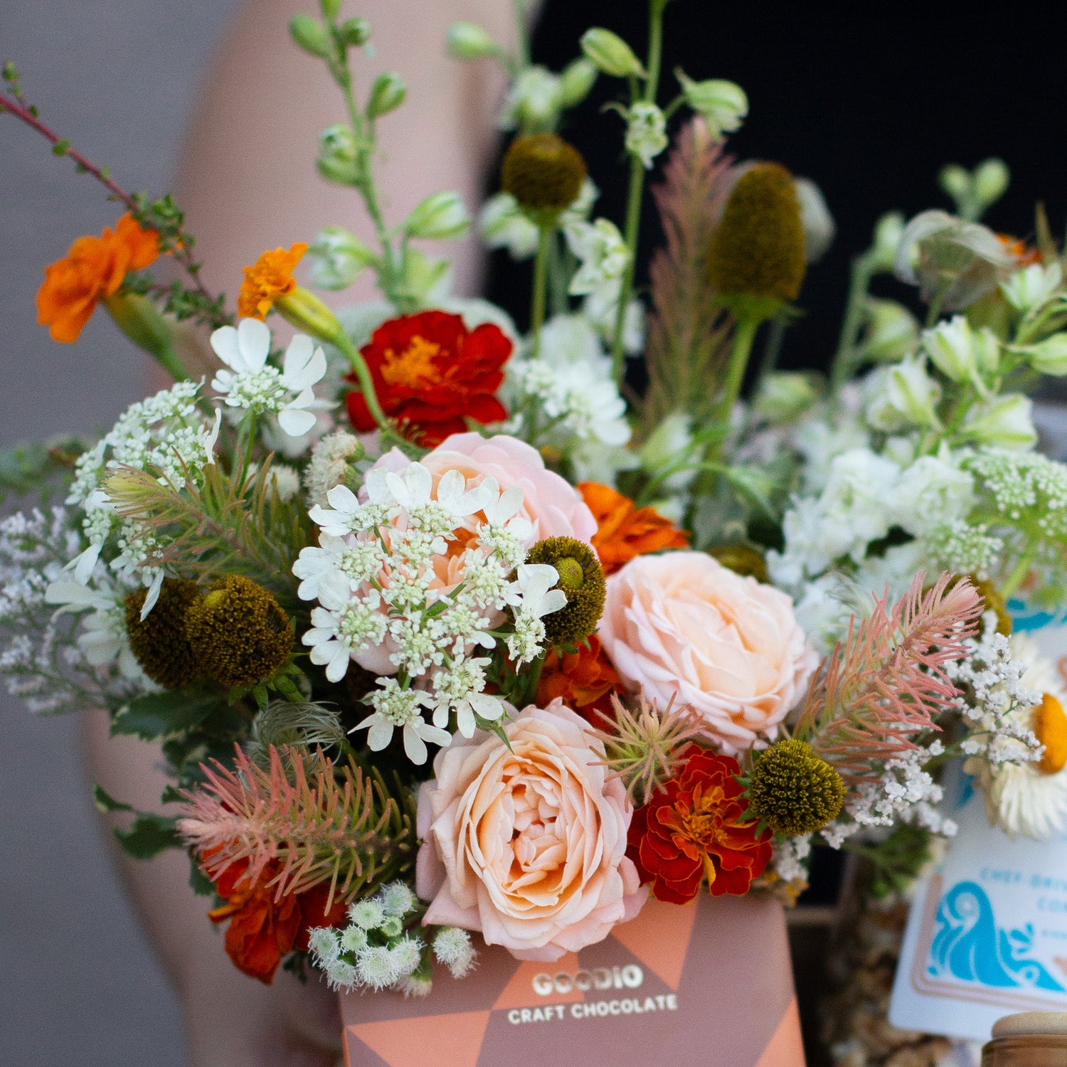 a floral palette with peach, red, orange, and white, including spray rose, queen anne's lace, and marigolds.