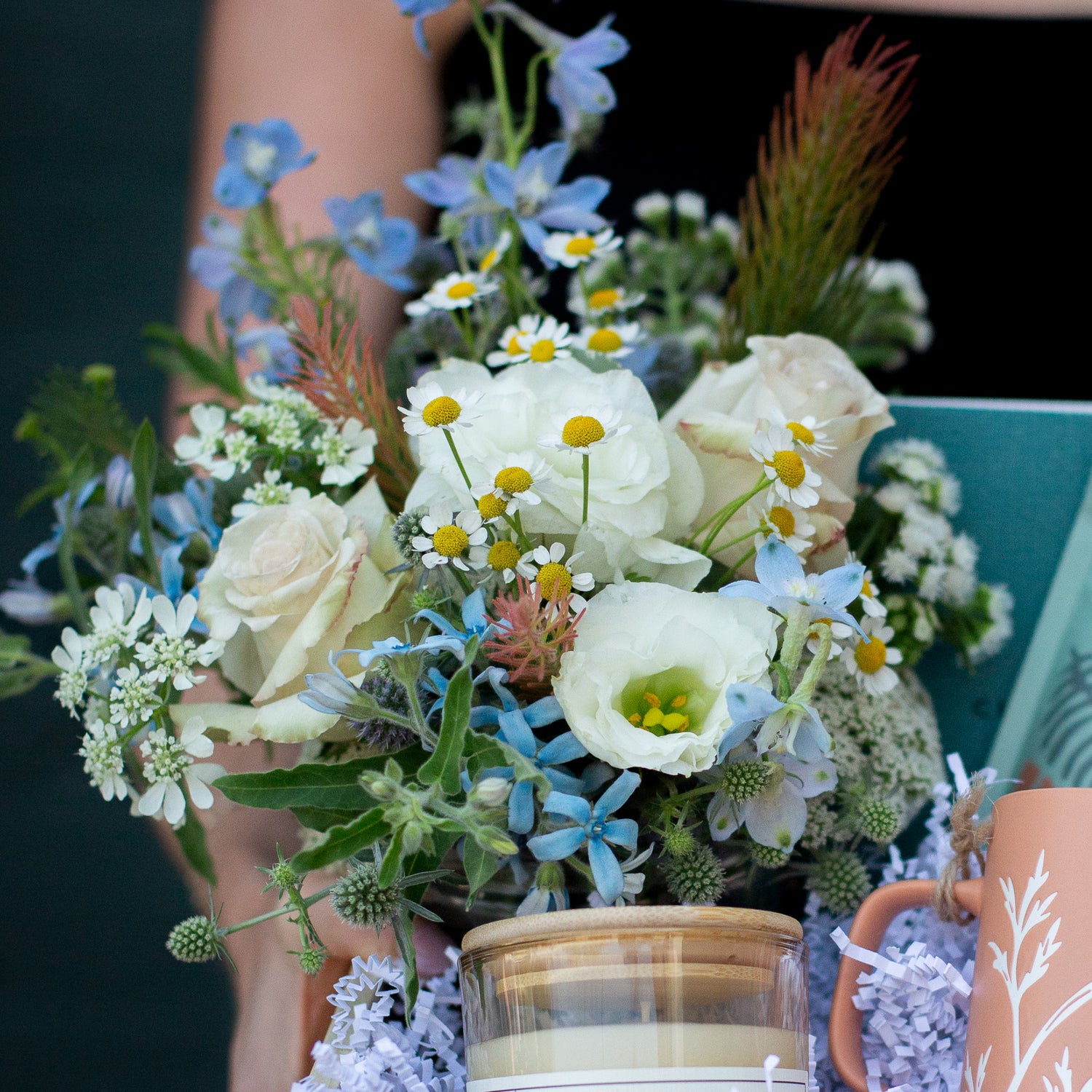 a floral palette with white, blue, green and yellow, including roses, chamomile, delphinium, and queen anne's lace