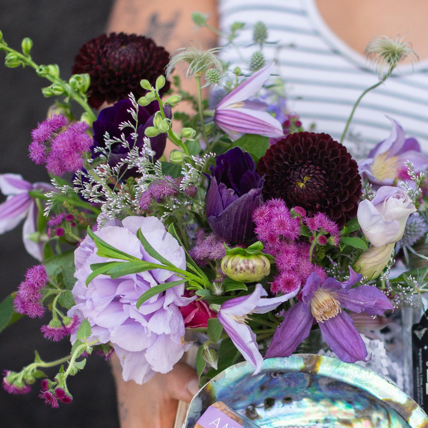 a floral palette with varying shades of purple, maroon, and fuchsia, including dahlias, clematis, lisianthus, and anemone 