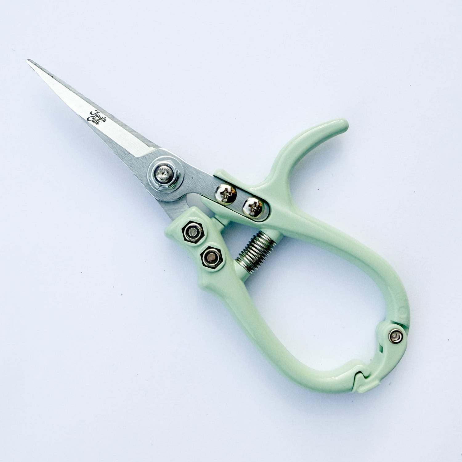 Mint green gardening shears on a light gray background