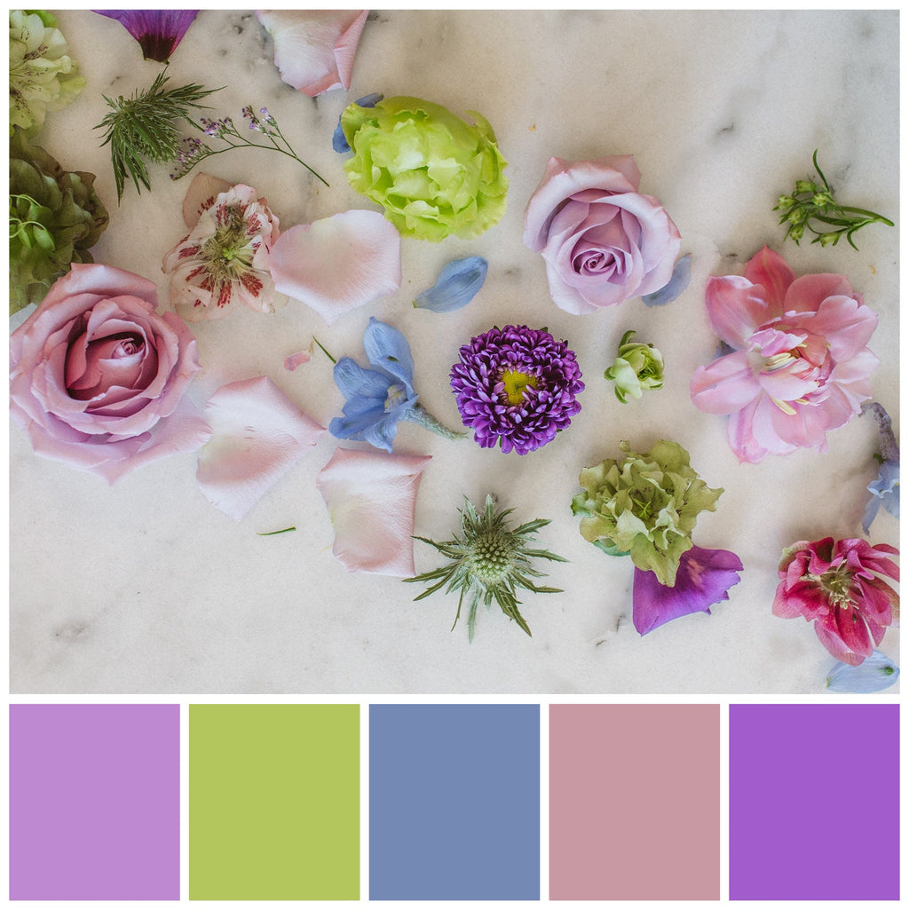 A color palette option: a flatlay of cool-colored blooms on a marble background. The colors included are greens, blues, purples, and cool pinks.
