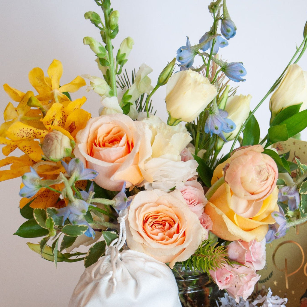 pastel peach, yellow, blue and white flowers